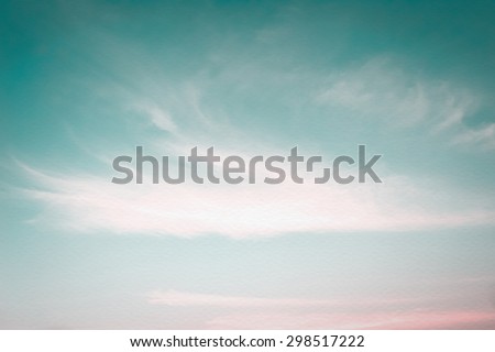 Vintage style blurred nature background of cyan blue pink sky and soft clouds on wind blowing movement on watercolor paper texture: Water colour textured paper with blurry soft retro sky on windy day