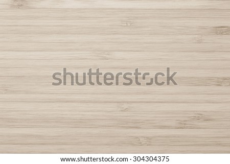 Wooden textured grainy detail backdrop in light sepia brown color tone: Bamboo wood laminated board detailed texture pattern background in sepia cream brown toned colour