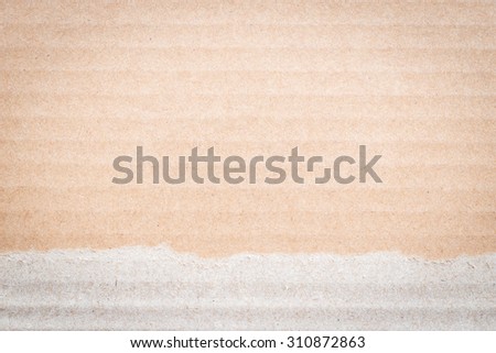 Torn Brown color cardboard paper detail texture patterned background: Cardboard textured pattern detailed backdrop in brown cream colour tone with torn edge
