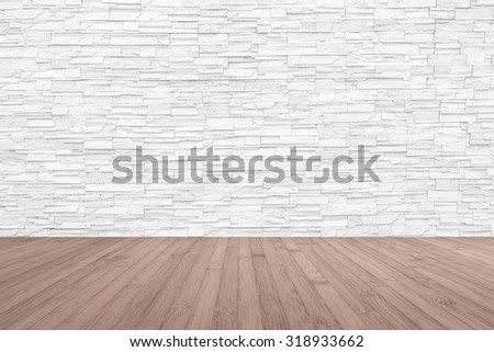 Limestone rock tile wall backdrop in light white grey color tone with wooden floor in dark red brown colour: Grunge vintage style room with rustic stone wall pattern background and wood flooring