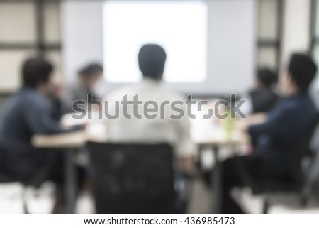 Blurred abstract background of business discussion people group or educational  presentation in meeting room with projector slide screen in front of table,  chair: Blurry view inside office interior - Stock Image - Everypixel