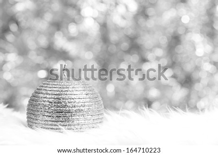 Silver candle over silver shiny background