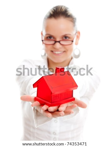 Lovely young woman offering a miniature red house to us, white background