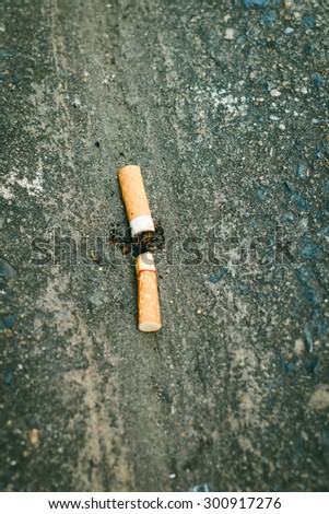 Cigarette butts on dirty street.It\'s destruction of the natural environment