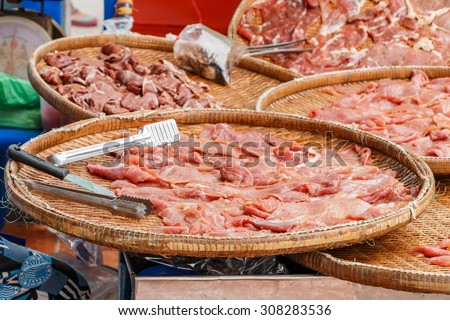 Fresh chicken meat sliced on the basket for sell in the market, selective focus