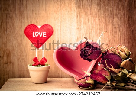 heart and dry roses for my love on wood background,vintage color tone,valentine day,still life