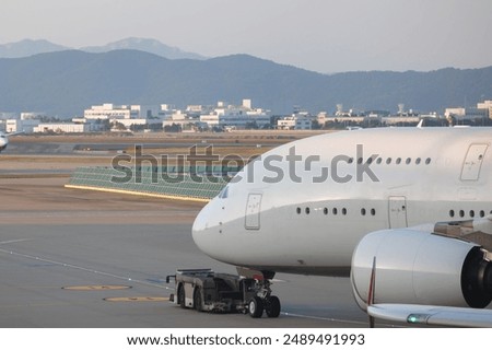 Similar – Image, Stock Photo Airliner plane parked at the terminal view from the front cockpit fuselage, on runway at night