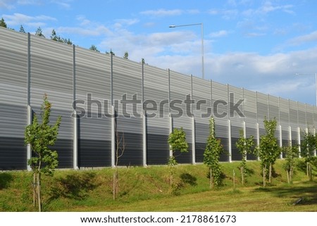 A noise barrier (also called a soundwall, noise wall, sound berm, sound barrier, or acoustical barrier) is an exterior structure designed to protection of people against noise.  Foto stock © 