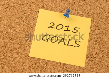 Yellow sticky note on an office cork board. 2015 Goals
