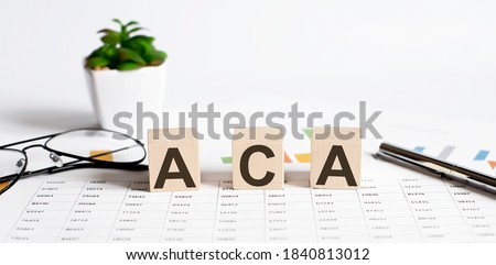 ACA written on a wooden cube on chart background Imagine de stoc © 