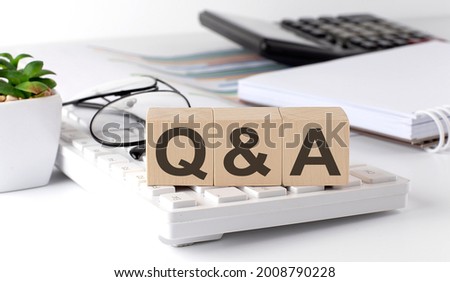 Q and A written on a wooden cube on the keyboard with office tools Stock foto © 