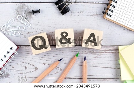 Q and A text on the wooden block with office tools on wooden background Stock foto © 