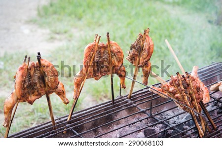 Roast chicken shop dividing the wayside in thailand,hot roasting chicken on smoked grill barbecue, thai local food