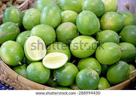 green lemons in fruit market, lemon background
