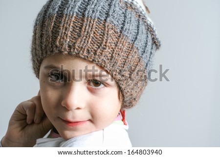 Little girl whit a pom pom hat