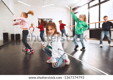 The kids at dance school. Ballet, hiphop, street, funky and modern dancers over studio background. Children showing aerobic element. Teens in hip hop style. Sport, fitness and lifestyle concept. Foto stock © 