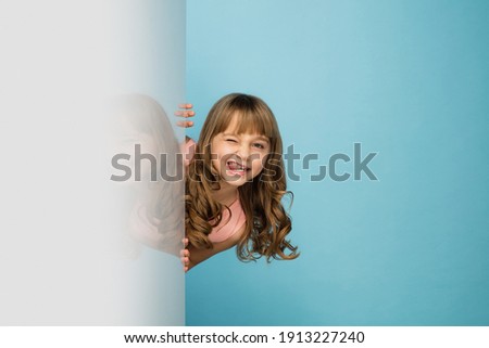 Image, Stock Photo A cute girl plays on her phone while her sister does her homework. Communication, social distance during quarantine. Distance learning, online education