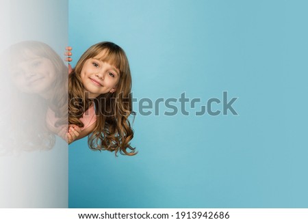 Similar – Image, Stock Photo A cute girl plays on her phone while her sister does her homework. Communication, social distance during quarantine. Distance learning, online education