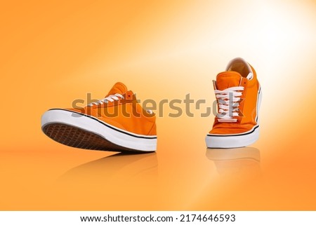 Walk. Modern unisex footwear, sneakers isolated on orange background. Fashionable stylish sports casual shoes. Creative minimalistic layout with footwear. Mock up for design, ad for shoe store Photo stock © 