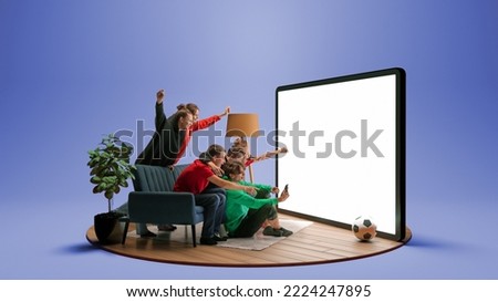 Goal. Group of young emotional friends watching football match, sport show or movie together. Excited girls and boys sitting in front of huge 3D model of device screen at home interior Foto stock © 