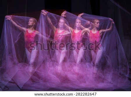 photo as art - a sensual and emotional dance of beautiful ballerina through the veil on a dark background. A stroboscopic image of the one model