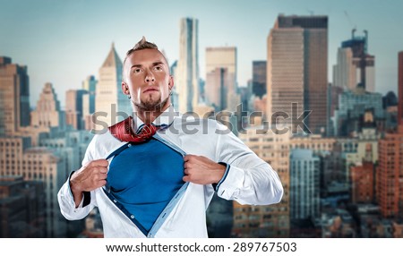 businessman acting like a super hero and tearing his shirt off against the background of Manhattan skyscrapers