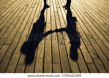 Similar – Foto Bild Schatten von zwei Personen auf dem Kopfsteinpflaster