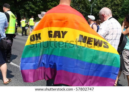 WARSAW, POLAND - JULY 17: An unidentified gay from UK with rainbow flag in Europride on July 17, 2010 in Warsaw, Poland.