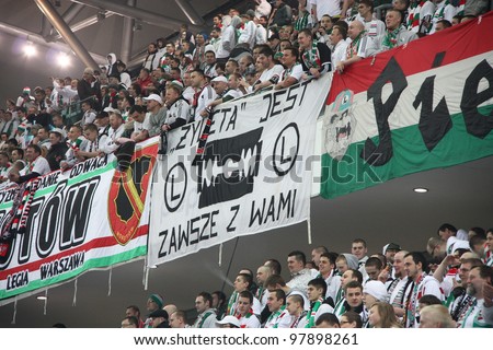 WARSAW, POLAND - MARCH 16: Fanatical fans of Legia Warsaw during the Warsaw\'s football derby between Legia Warsaw vs Polonia Warsaw on March 16, 2012 in Warsaw, Poland. Final results: 0:0