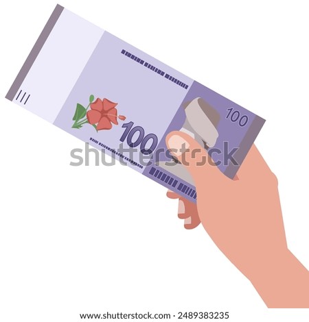 Hand holding one hundred Ringgit Malaysia currency banknote cash paper money.