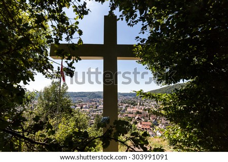 WETTINGEN, AARGAU, SWITZERLAND - JULY 21: Views from the Mountain Sulperg with the white cross to the village of Wettingen on July 21, 2015. Wettingen is a municipality in the Swiss canton of Aargau.