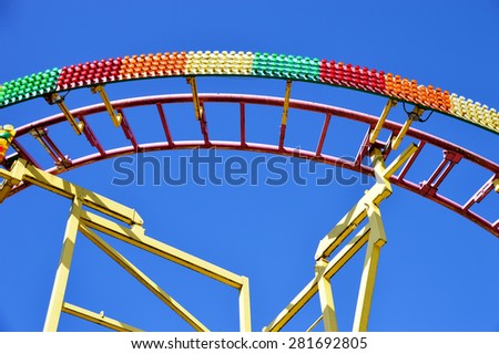 Curved Rail of a Roller Coaster with colorful Light Bulbs