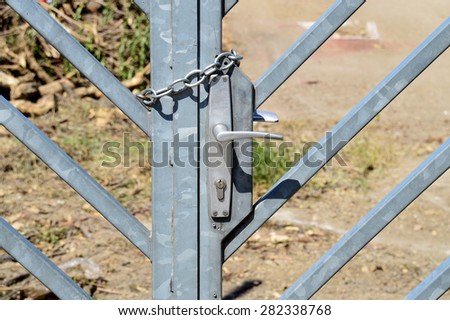 Iron Chain on a barred Double Gate