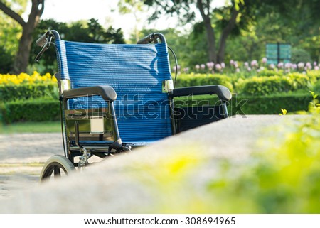 Wheelchair in the Garden in morning ,under Sun light with shadow