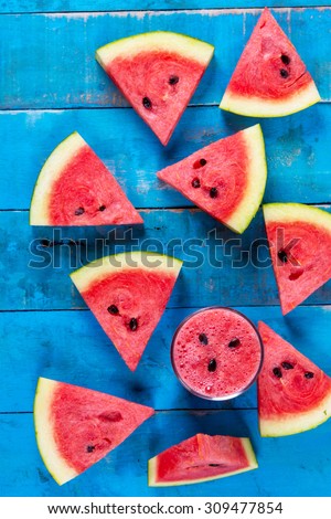 Fresh water melon drink  and water melon slice on Blue wood Top view