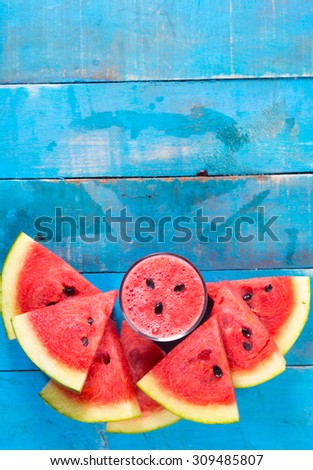 Fresh water melon drink  and water melon slice on Blue wood Top view,with space