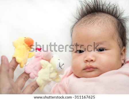 Asian Baby looking to her mother play Finger Puppets