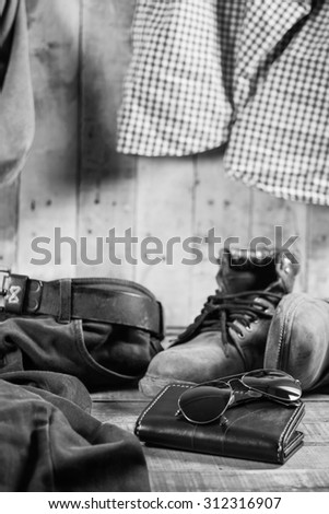 Still Life Black and White with casual man,Sunglasses,Wallet,Boots,Belt,Trousers