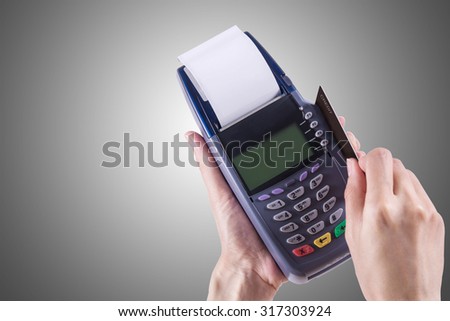Women Hands swiping Credit card on Credit card machine or Credit card Terminal