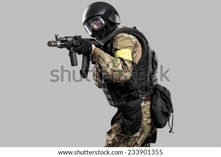 one soldier holding assault rifle ak-74. Uniform conforms to special services FSB (soldiers) of the Russian Federation. Shot in studio. Isolated with clipping path on grey background