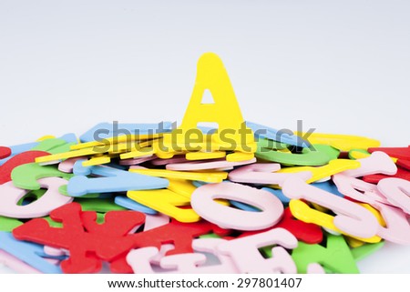 Alphabet A on the top of the hill of pile other alphabet with red, yellow, green, pink and blue colour, education and leading concept, selective focus