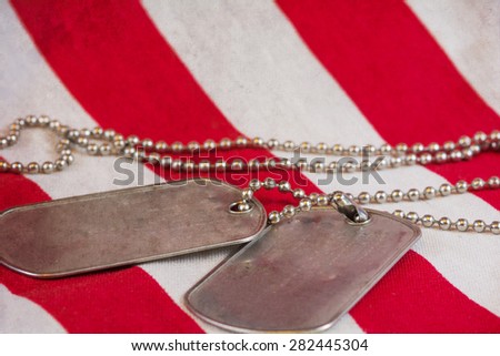 American Flag underneath dog tags with texture vintage appearance