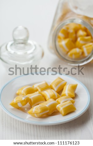 Close-up of hard yellow candy with white stripes.