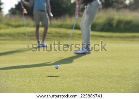 golfer goes for hole / do you think he will make it / well of course you do