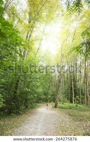 Child Running On Forest Trail