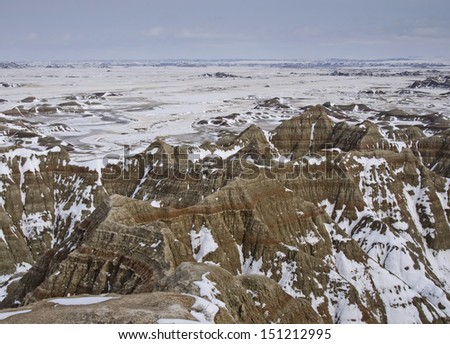 Badlands National Park after an early spring snowfall. The park, in southwestern South Dakota, consists of  sharply eroded buttes, pinnacles and spires surrounded by a mixed-grass prairie ecosystem.