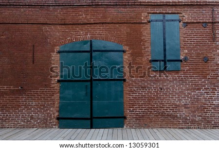 Green metal shutters on gold-rush era brick building in Columbia, California