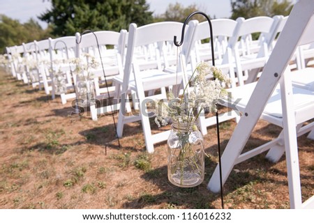 Wedding Aisle with Mason Jars Filled with Baby\'s Breath