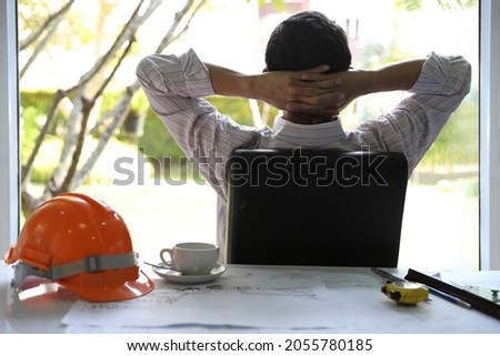 Exerciise Relaxing young architect man looking at outdoor the office working with drawing and sketching a construction project Foto stock © 
