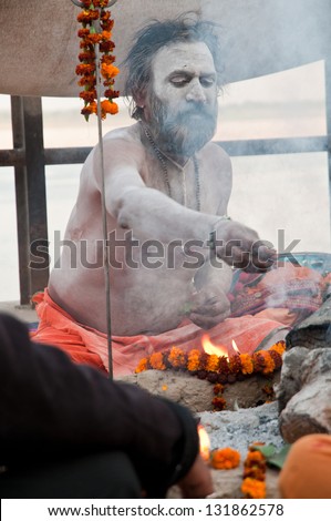 VARANASI, INDIA - MARCH 10: A hindu saint performs yagna prayer rituals of Lord Shiva on the auspicious Maha Shivaratri festival on March 10, 2013 at Varanasi, Uttar Pradesh, India.